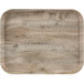 A light olive Cambro fiberglass cafeteria tray with a wood surface.