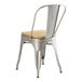 A Lancaster Table & Seating metal chair with a natural wood seat.