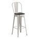 A Lancaster Table & Seating metal barstool with a black wood seat and silver legs.