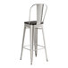 A Lancaster Table & Seating metal cafe barstool with a black seat.