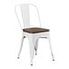 A white Lancaster Table & Seating metal cafe chair with a walnut wood seat.