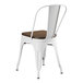 A white Lancaster Table & Seating metal cafe chair with a wooden seat.