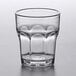 A Carlisle clear plastic tumbler with a rounded bottom and curved edge.