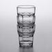 A stack of Carlisle clear plastic tumblers on a table.