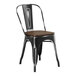 A Lancaster Table & Seating black metal chair with a walnut seat.