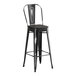 A black Lancaster Table & Seating barstool with a black wood seat.