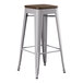 A Lancaster Table & Seating gray metal barstool with a walnut wood seat.