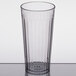 A clear Carlisle plastic tumbler with a black rim on a table.