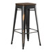 A Lancaster Table & Seating black metal barstool with a walnut wood seat.