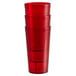 A stack of Carlisle Ruby red plastic tumblers.