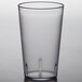 A Carlisle clear plastic tumbler with a black rim.