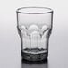 A Carlisle smoke plastic tumbler with a rim on a table.