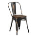 A black metal Lancaster Table & Seating cafe chair with a walnut wood seat.