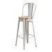 A Lancaster Table & Seating metal barstool with a natural wood seat.