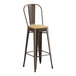 A brown metal Lancaster Table & Seating bar stool with a natural wood seat.