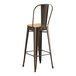 A Lancaster Table & Seating copper barstool with a natural wood seat.