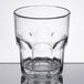 A Carlisle clear plastic tumbler with a curved rim.