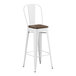 A white Lancaster Table & Seating barstool with a walnut seat.