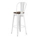 A white metal Lancaster Table & Seating bar stool with a walnut wood seat.