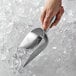 a hand holding a scoop of ice