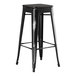 A Lancaster Table & Seating black metal barstool with black wood seat.