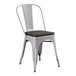 A Lancaster Table & Seating gray metal chair with a black wood seat.