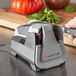 A person using a Wusthof electric knife sharpener on a knife.