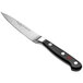 A Wusthof Classic forged paring knife with a black handle.