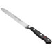 A Wusthof Classic forged serrated utility knife with a black handle.