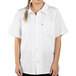A woman wearing a white Uncommon Chef cook shirt with a braid.