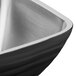 A close-up of a black Vollrath double wall square metal bowl.