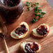 A spoon spreading Dalmatia Fig Cocoa Spread on a piece of bread.