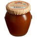 A jar of Dalmatia Organic Apricot Spread with a paper lid.