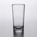 A Carlisle Alibi reusable plastic hi ball glass with a clear bottom and black rim.