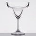 A clear Carlisle plastic margarita glass with a stem and a rim.