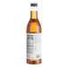 A close up of a bottle of Capora Caramel Flavoring Syrup with a white label.