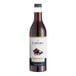 A bottle of Capora Chocolate Syrup on a white background.