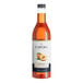 A bottle of Capora Peach Flavoring Syrup with a white label.