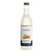 A white bottle of Capora Almond Flavoring Syrup with a gold label.