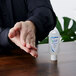 A person holding a Kutol Health Guard hand sanitizer squeeze bottle.