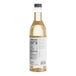A close up of a bottle of Capora White Chocolate flavoring syrup with a white label.