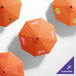 A customized California Umbrella with an orange Sunbrella canopy and white text.