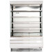 A white Turbo Air air curtain merchandiser with glass shelves.