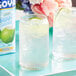 A close-up of two glasses of coconut water with lime slices.