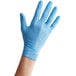 a hand wearing a blue glove