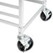 A metal frame for sheet pan racks with black swivel stem casters.