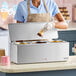 A triple cone dip warmer with three compartments for holding and warming dessert toppings.