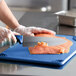 a person cutting a piece of meat