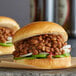 A close-up of a sandwich with beans on it.