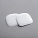 A pair of white Fox Run nylon pan scrapers.